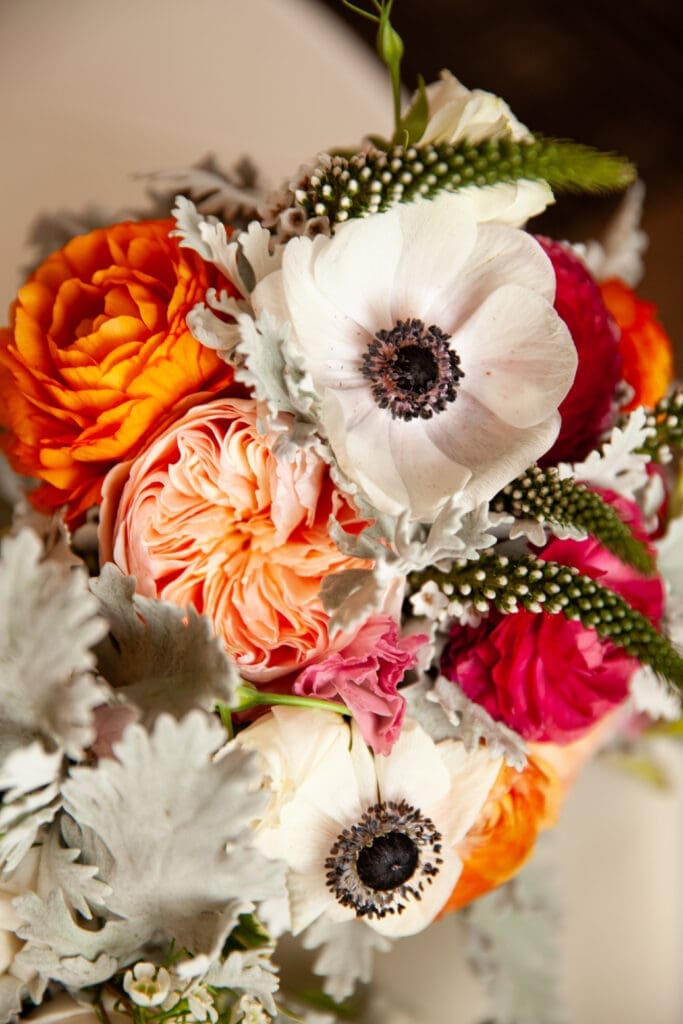 Romantic bouquet of anemones garden roses wax flowers lesanthus and Dusty Miller bridal bouquet details.