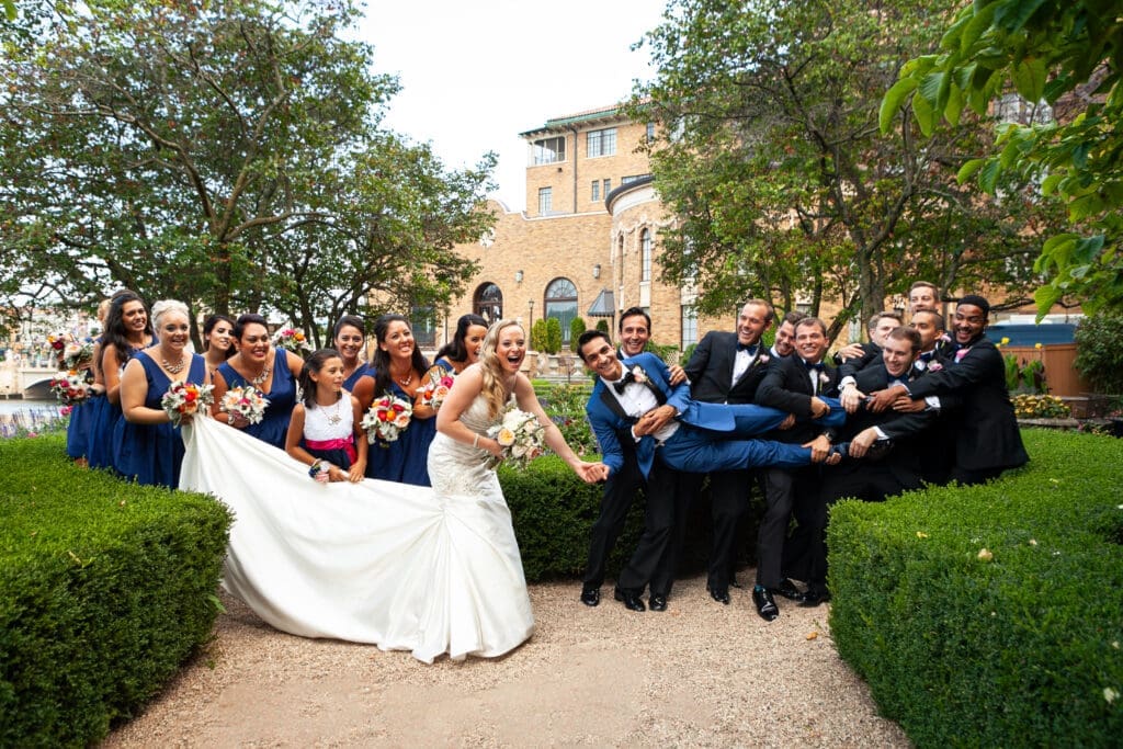 Laughing silly bridal party at Hotel Baker picking up the groom.