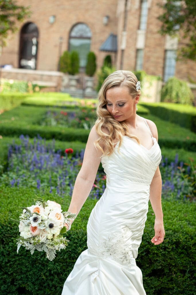 Bride posing with flowers at Hotel Baker.