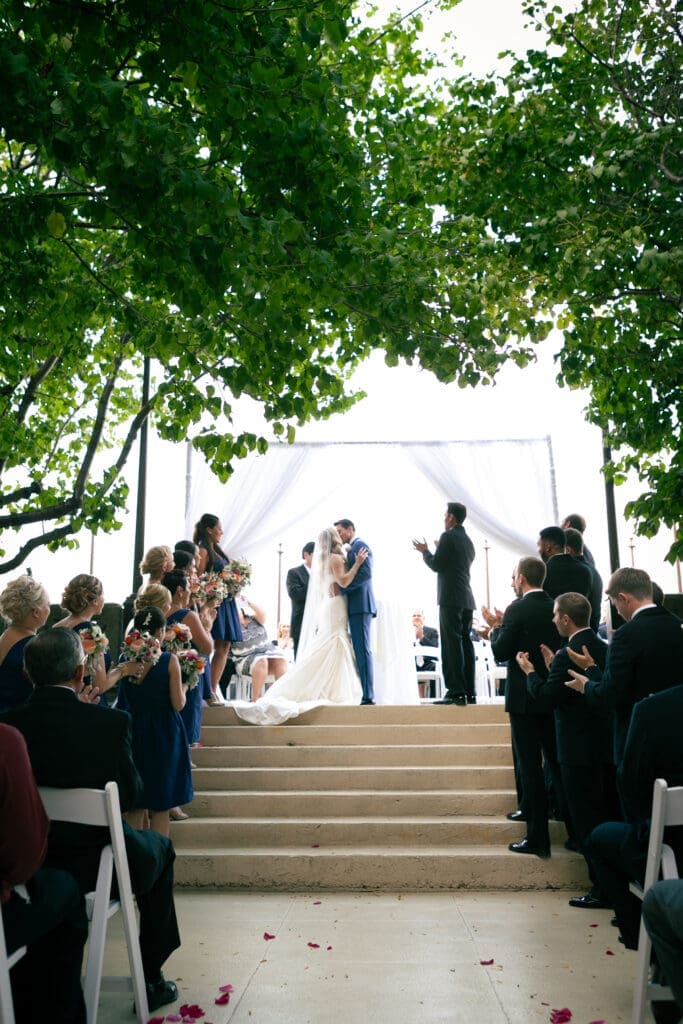 Bride and groom have their first kiss together at St Charles Hotel Baker.