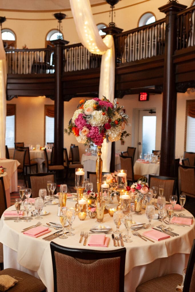 Guest table decorated with flower centerpiece for wedding at Hotel Baker.
