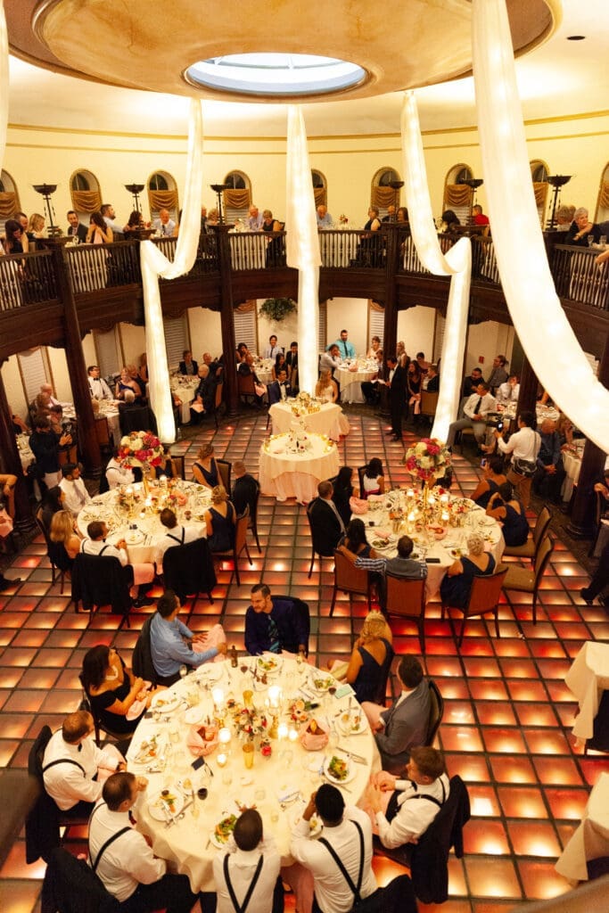 Guests at a wedding in the Rainbow Room at Hotel Baker.