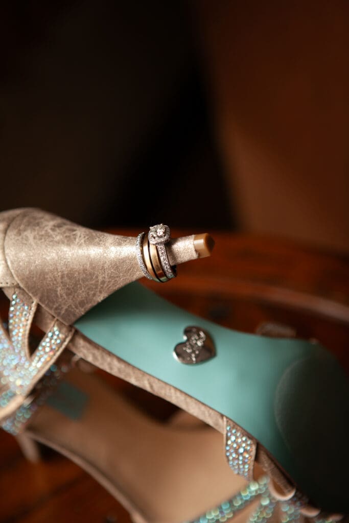 Wedding rings on heel of shoe at Hotel Baker Saint Charles Illinois.
