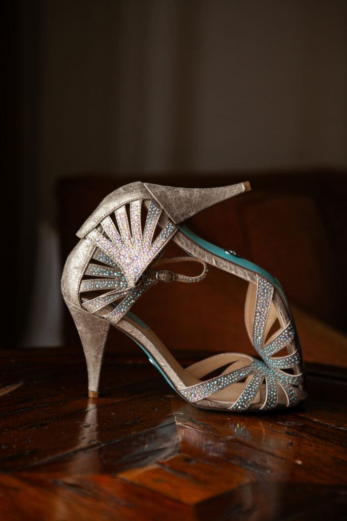 Vintage luxury wedding shoes stacked on each other with natural light.