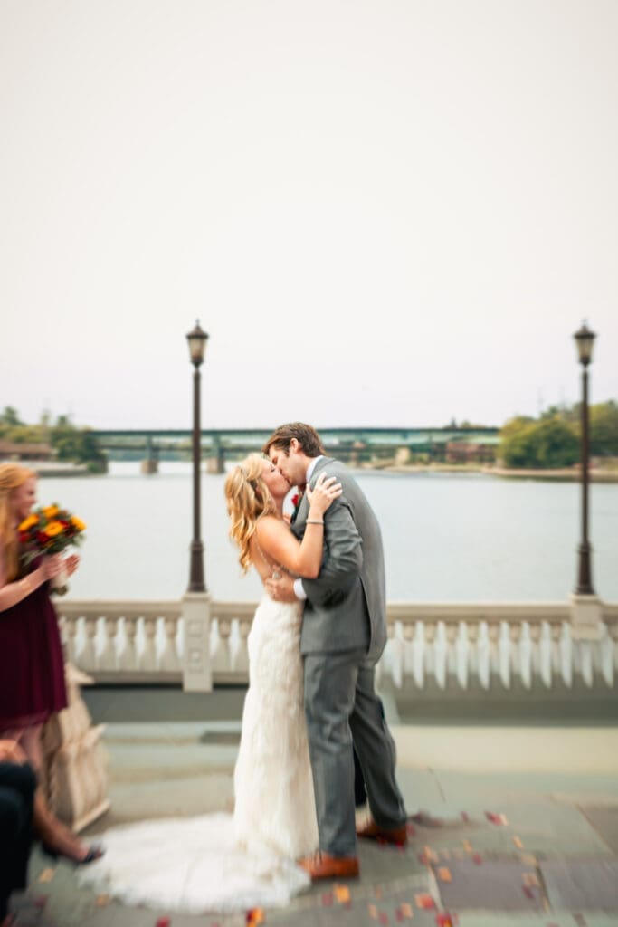 Action shot of the first kiss in front of the Fox River in Saint Charles at Hotel Baker.