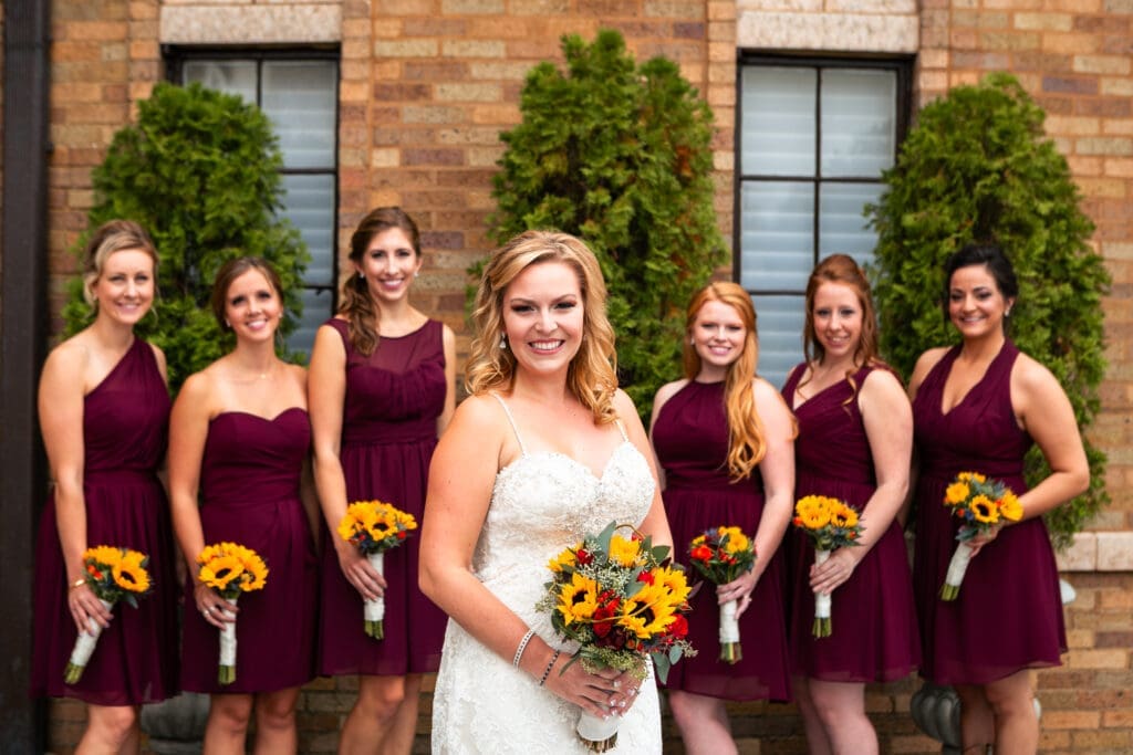 Bride with bridesmaids posing at Hotel Baker St. Charles IL