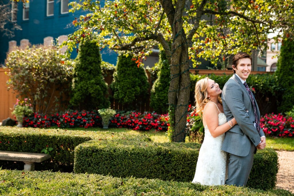 Bride and groom smiling before seeing each other for the first look at Hotel Baker St. Charles.