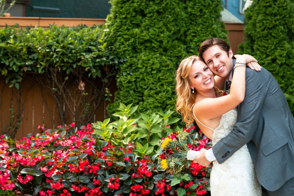 Bride and groom with their arms all over each other at Hotel Baker.