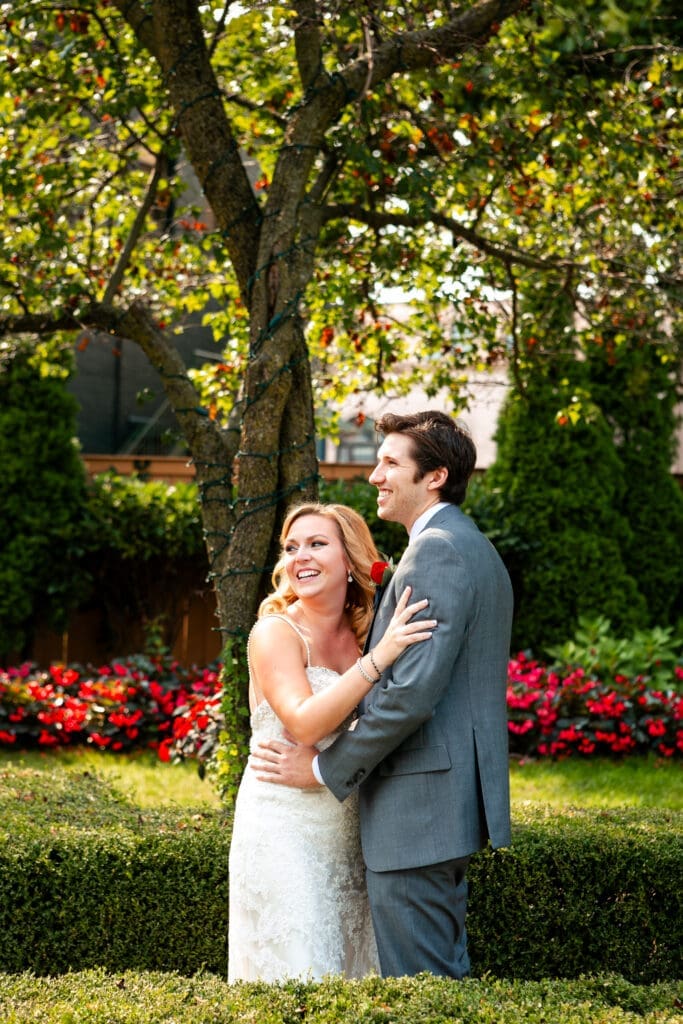 A beautiful bride and groom smiling at Hotel Baker St. Charles and English Garden.