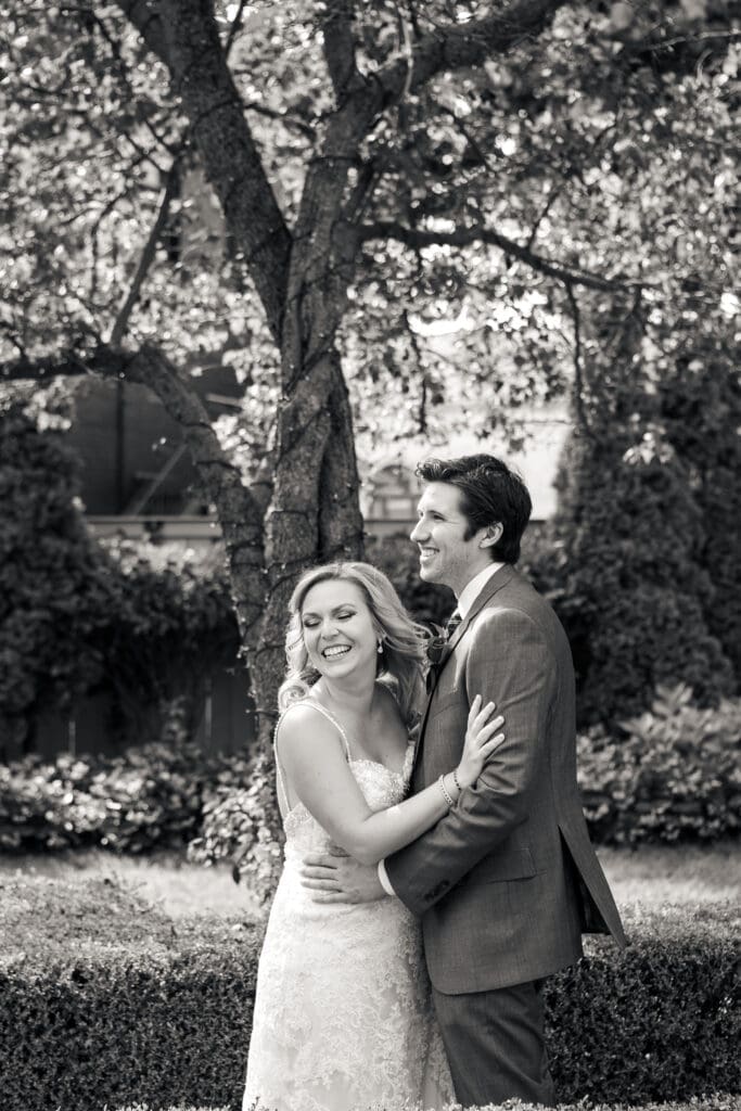 Black and white image of a smiling bride and groom at Hotel Baker.