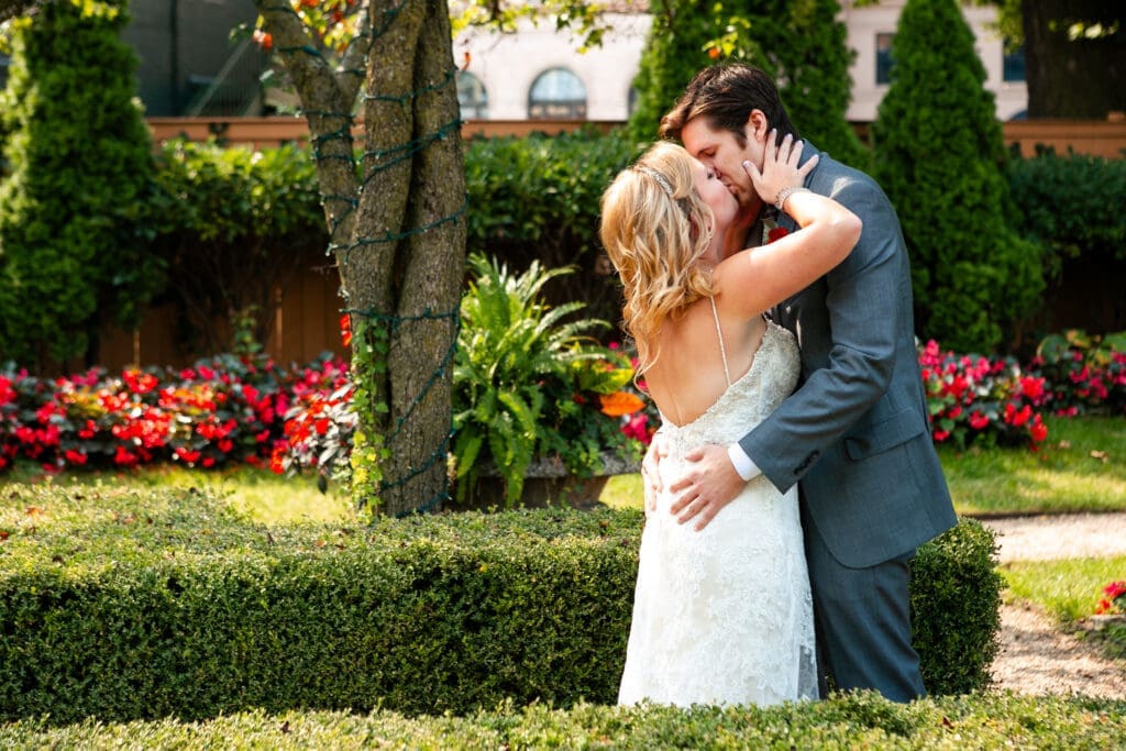 Bride and groom share a kiss before their ceremony at Hotel Baker.