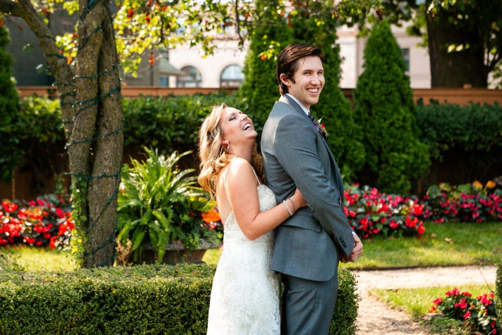 Bride holding onto groom before they see each other for the first time at Hotel Baker St. Charles.