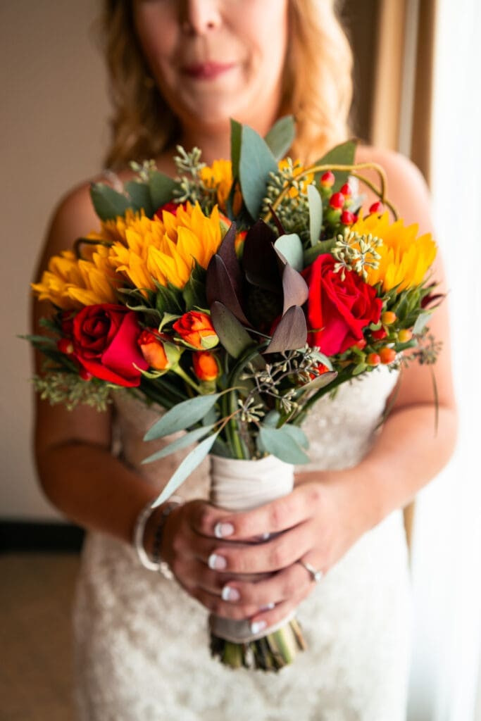 Bride holds her flowers in the bridal suite at Hotel Baker.