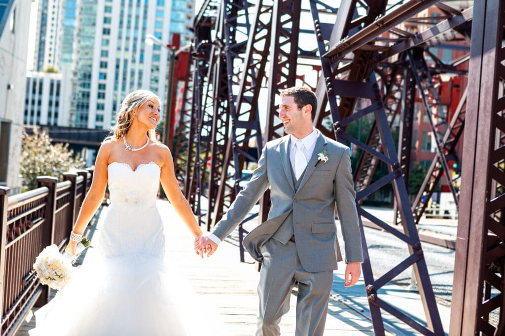 Bride and groom sharing a moment admiring each other on the iconic Kinzie Canal railroad bridge overlooking the Chicago River.