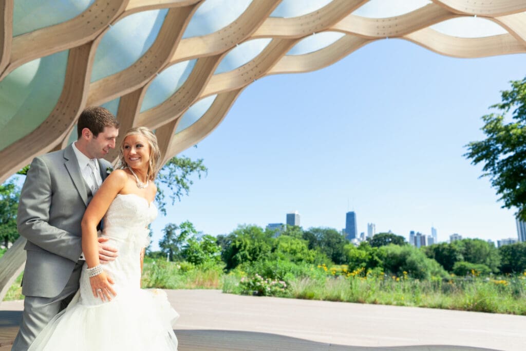 Bride and groom posing in front of the city skyline in Chicago.