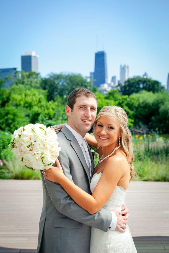 Classic bride and groom portrait in front of the Chicago city skyline at Lincoln Park Zoo.