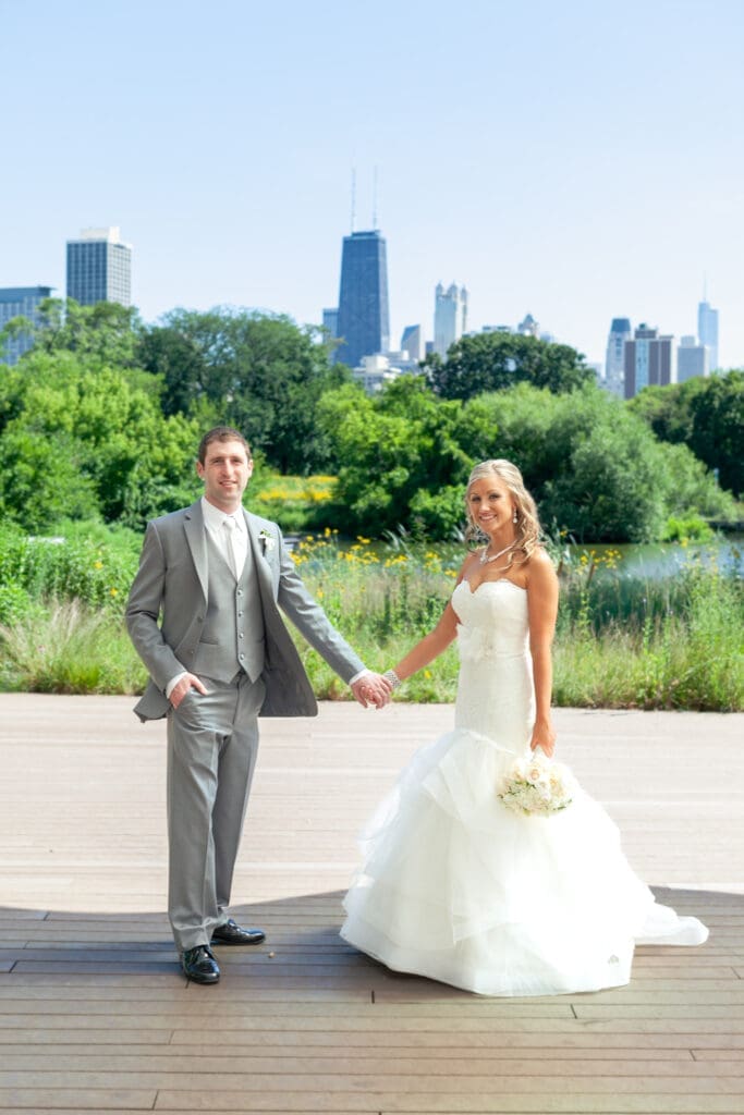 Bride and groom posing in front of the city skyline in Chicago.