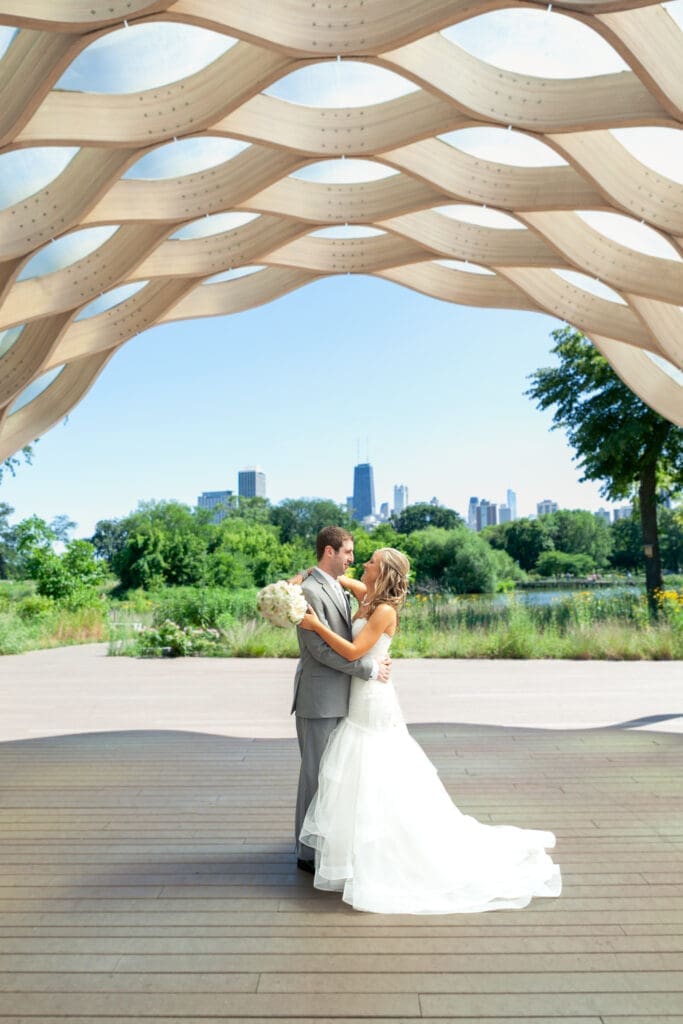 Bride and groom holding each other in the arch at Lincoln Park Zoo Chicago.