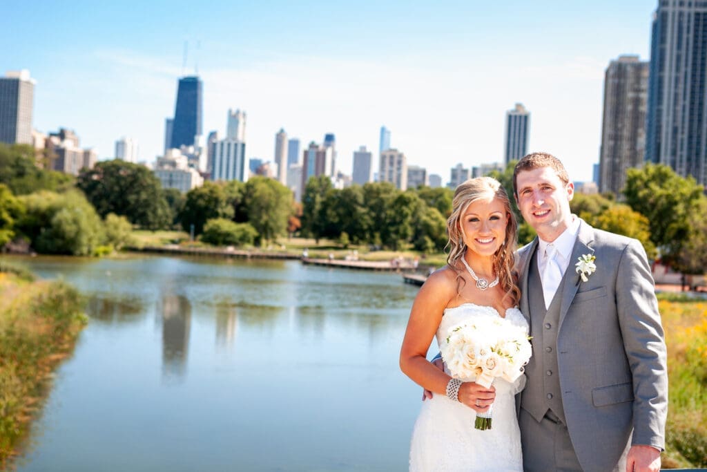 Bride and groom in front of the Chicago skyline at the North Pond at Lincoln Park Zoo.